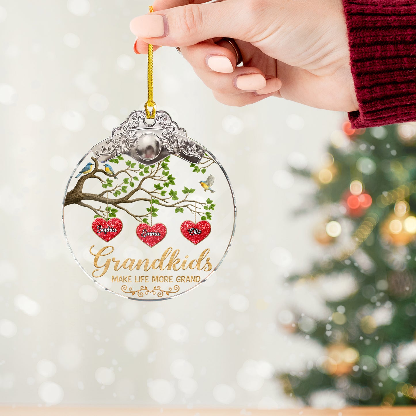 Personalized "Grandkids Make Life Grand" glass ornament with a silver and gold cap, showcasing family love.