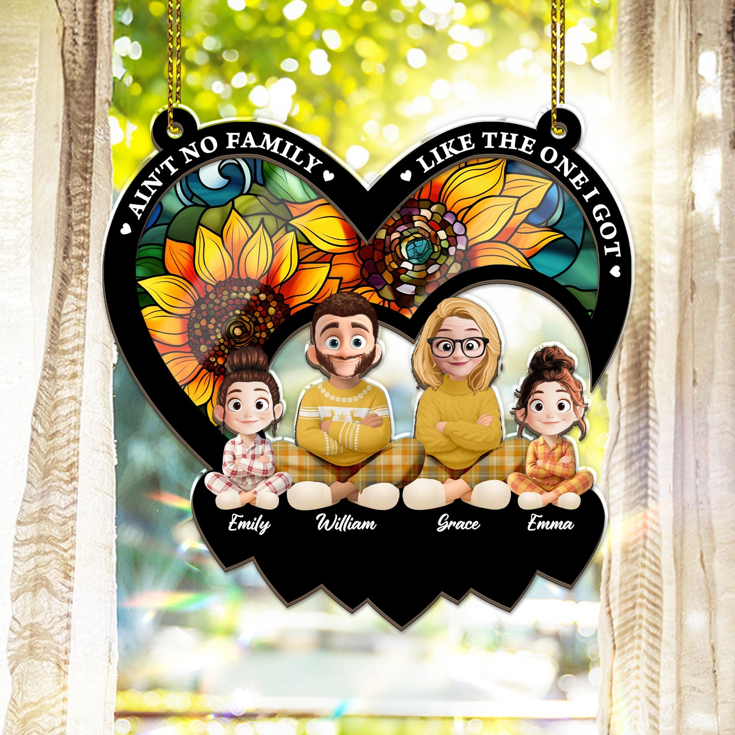 Personalized "Ain't No Family Like The One I Got" suncatcher ornament hanging in a window.