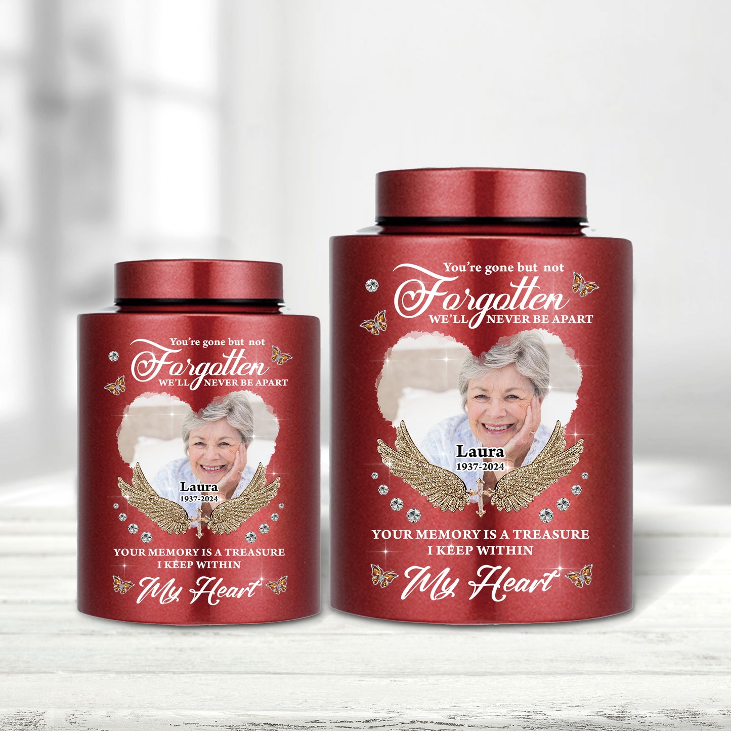 Stainless steel keepsake urn for ashes with "In Loving Memories" engraving, displayed on a dark surface.