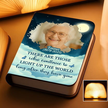 Personalized photo book lamp lit up, showcasing custom images and warm light.