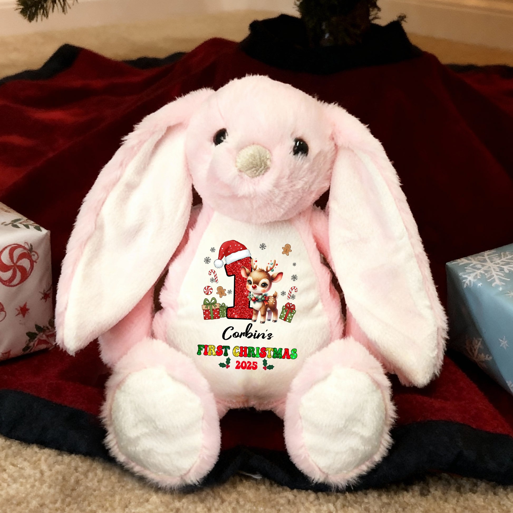 My First Christmas plush bunny rabbit with festive red bow and embroidered details.