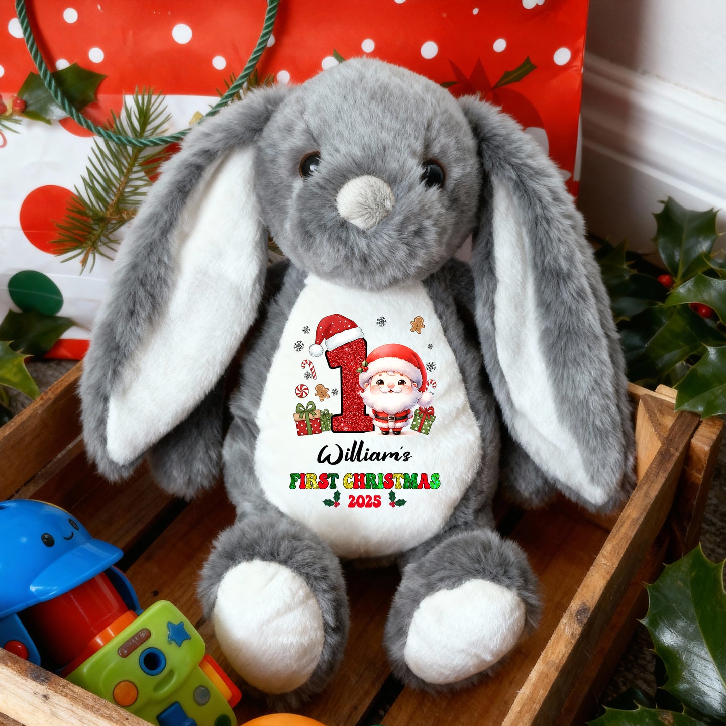 My First Christmas plush bunny rabbit with festive red bow and embroidered details.