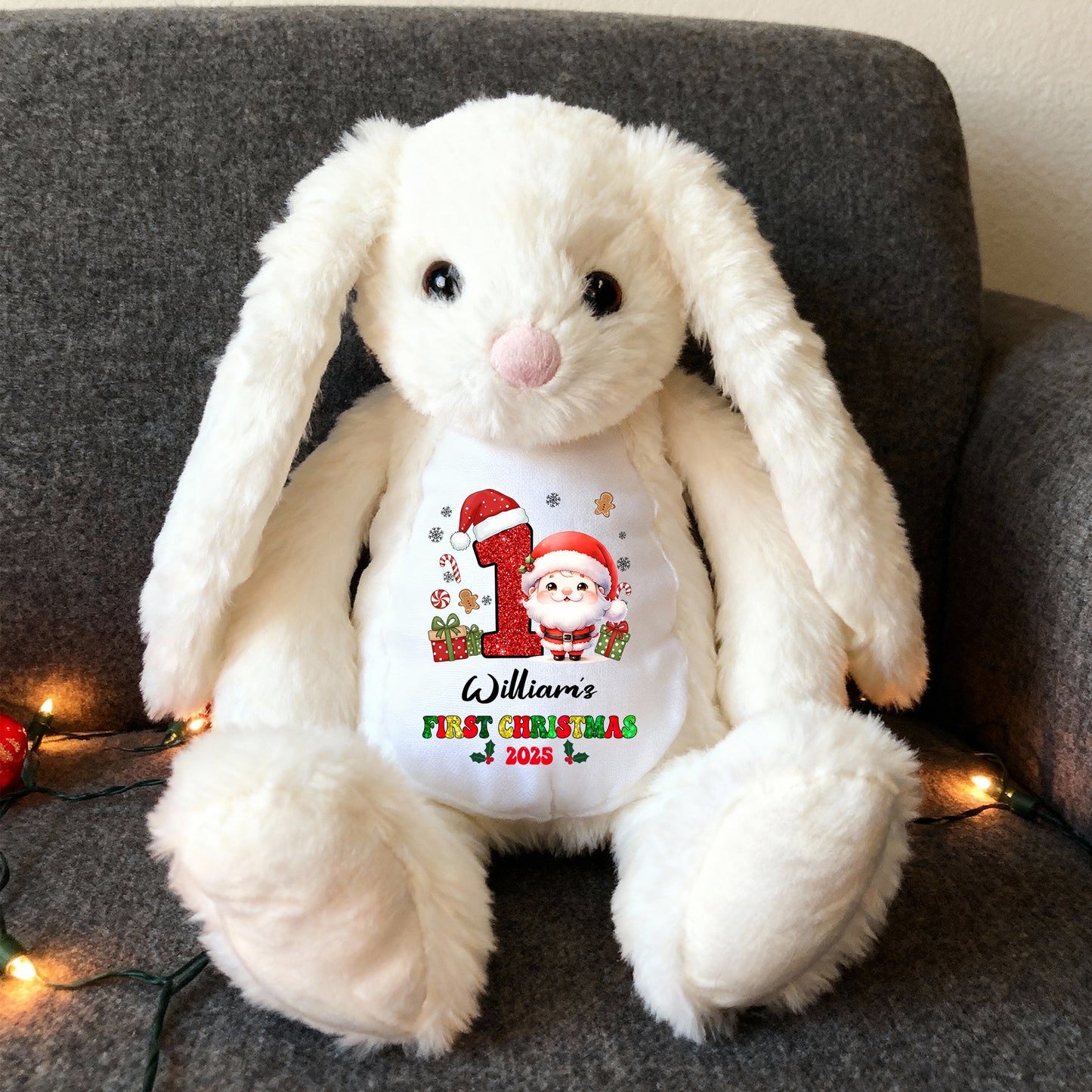 My First Christmas plush bunny rabbit with festive red bow and embroidered details.