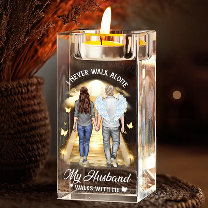 Personalized crystal candle holder with "Never Walk Alone" engraving, shimmering beautifully.