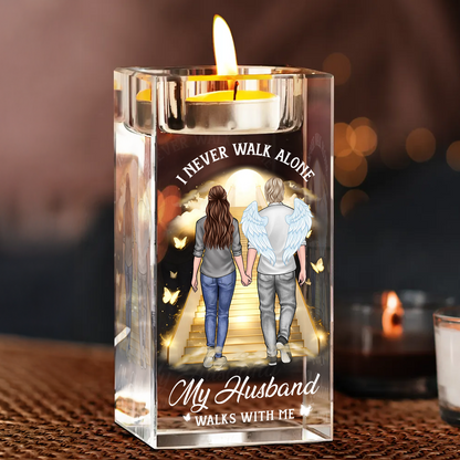 Personalized crystal candle holder with "Never Walk Alone" engraving, shimmering beautifully.
