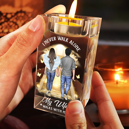 Personalized crystal candle holder with "Never Walk Alone" engraving, shimmering beautifully.