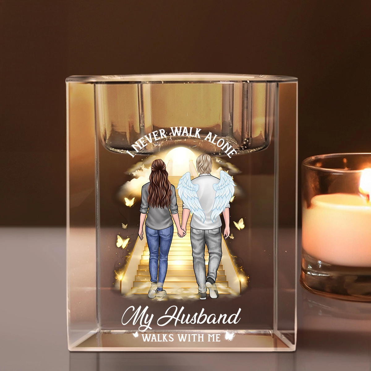 Personalized crystal candle holder with "Never Walk Alone" engraving, shimmering beautifully.