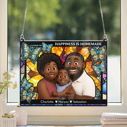 Personalized family photo stained glass suncatcher hanging in a window, creating colorful light.
