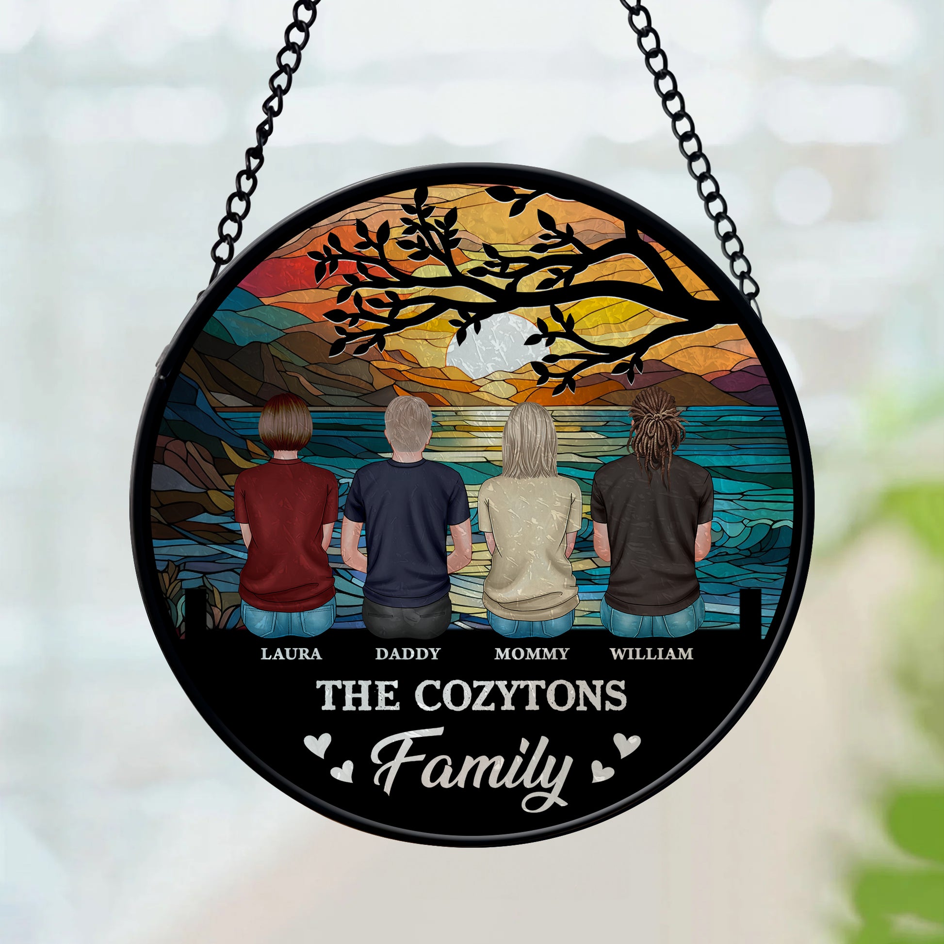 Personalized family photo stained glass suncatcher hanging in a window.