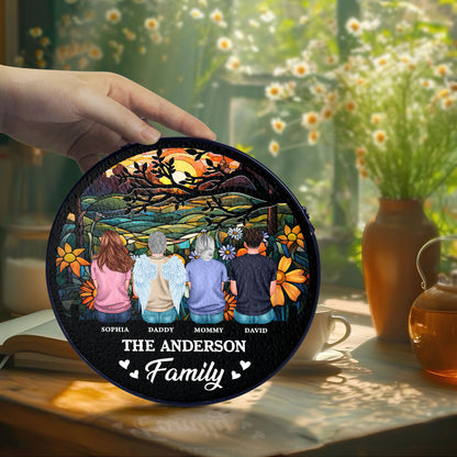 Personalized family photo stained glass suncatcher hanging in a window.