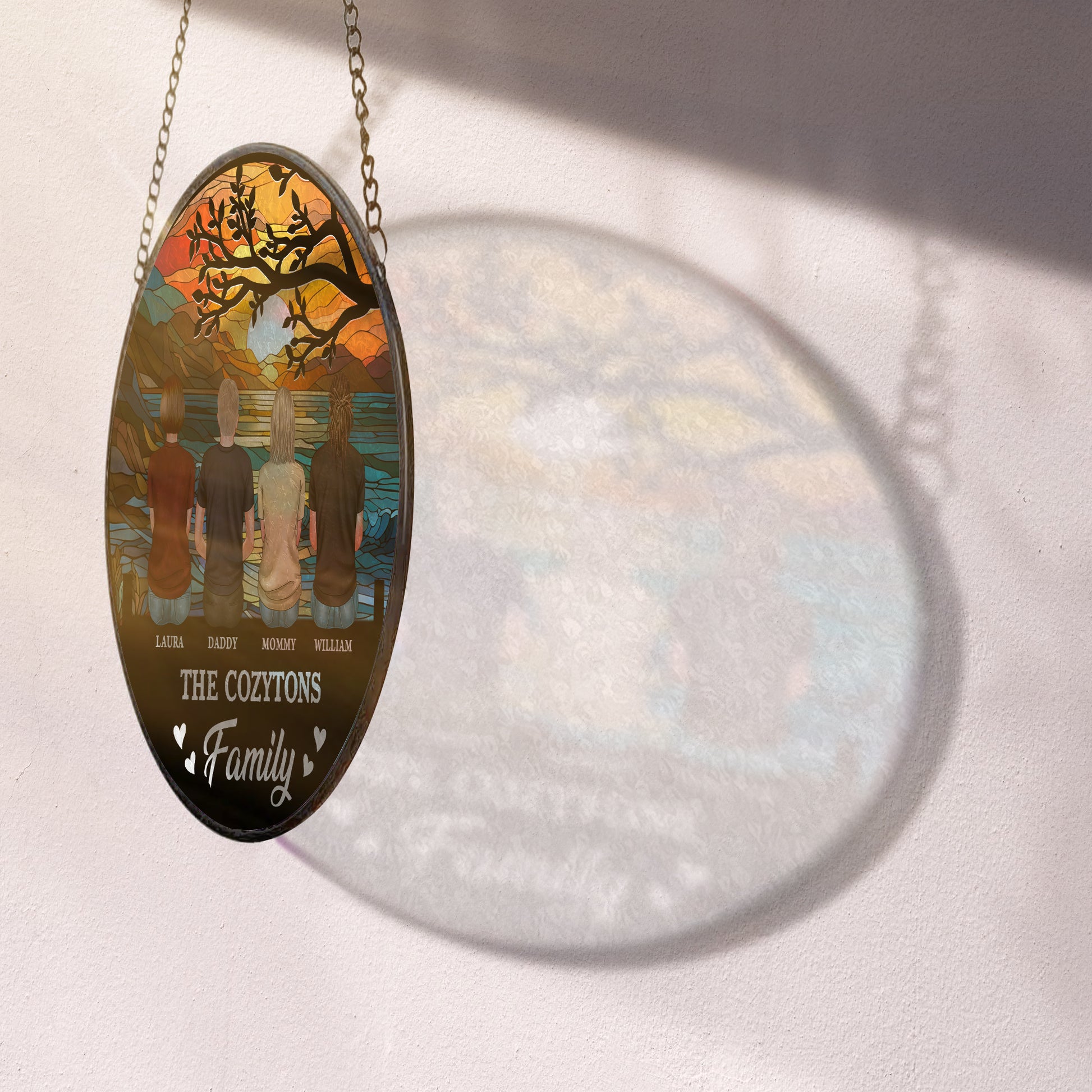 Personalized family photo stained glass suncatcher hanging in a window.