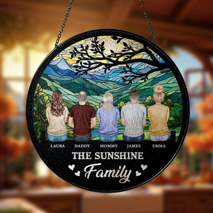 Personalized family photo stained glass suncatcher hanging in a window.