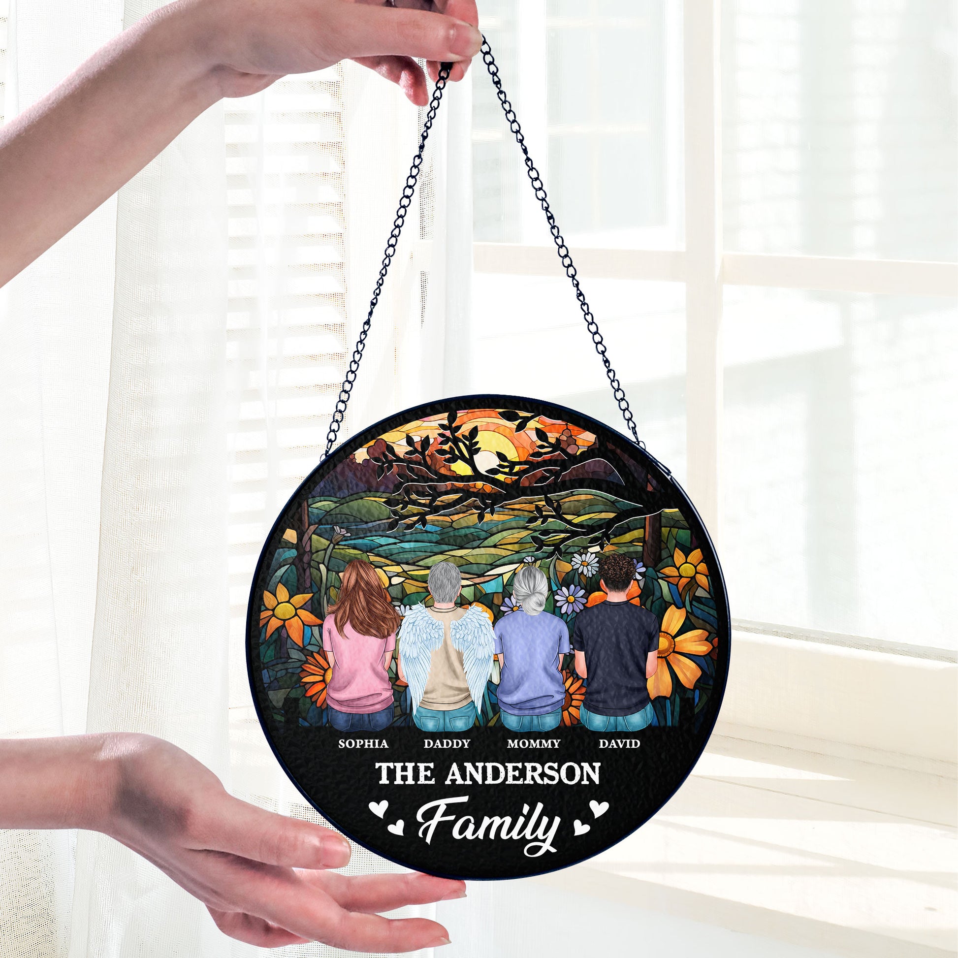 Personalized family photo stained glass suncatcher hanging in a window.