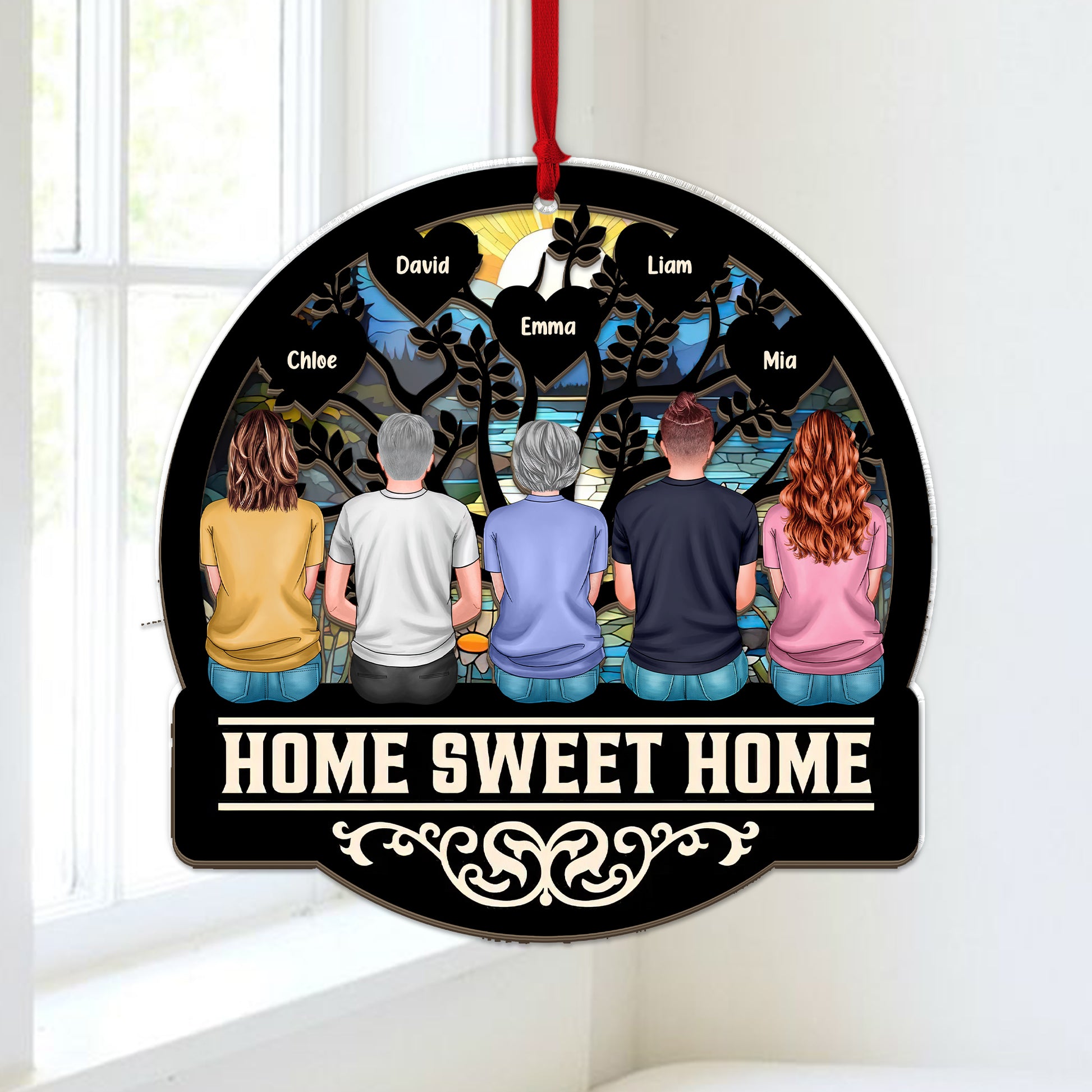 Personalized "Our Family This Christmas" window suncatcher ornament hanging.