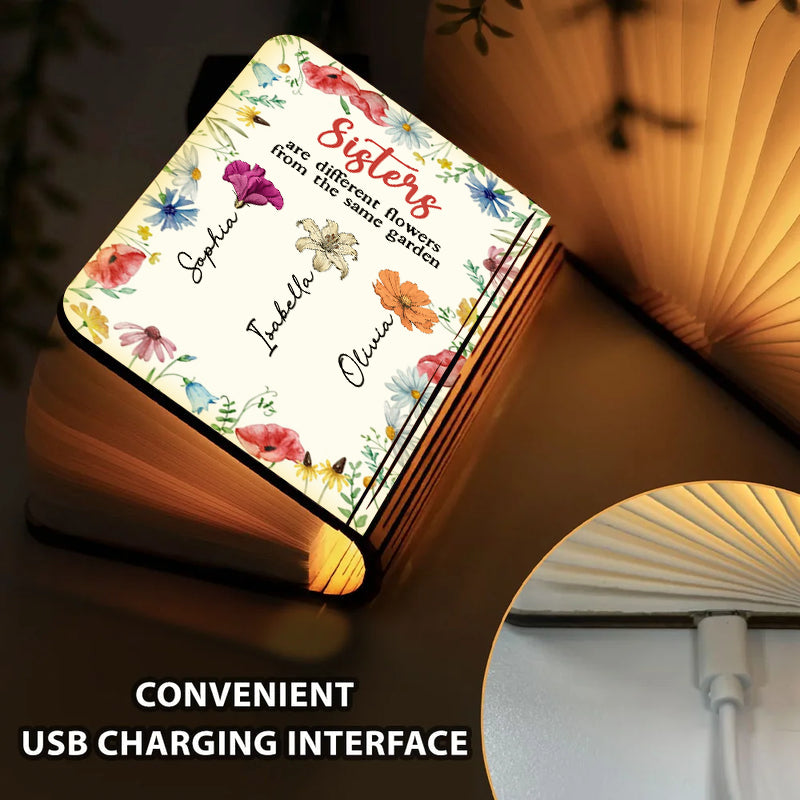 Sisters Are Different Flowers Personalized Book Lamp, showcasing custom engraving and warm light.