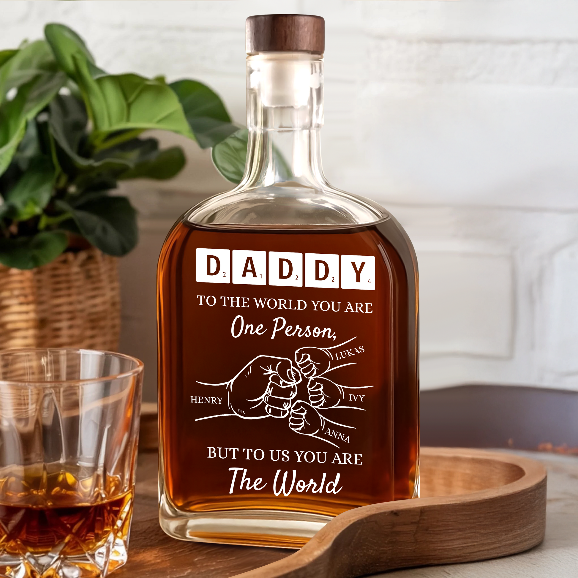 Personalized whiskey bottle with custom engraving that reads "To Your Family You Are The World, Our Family."