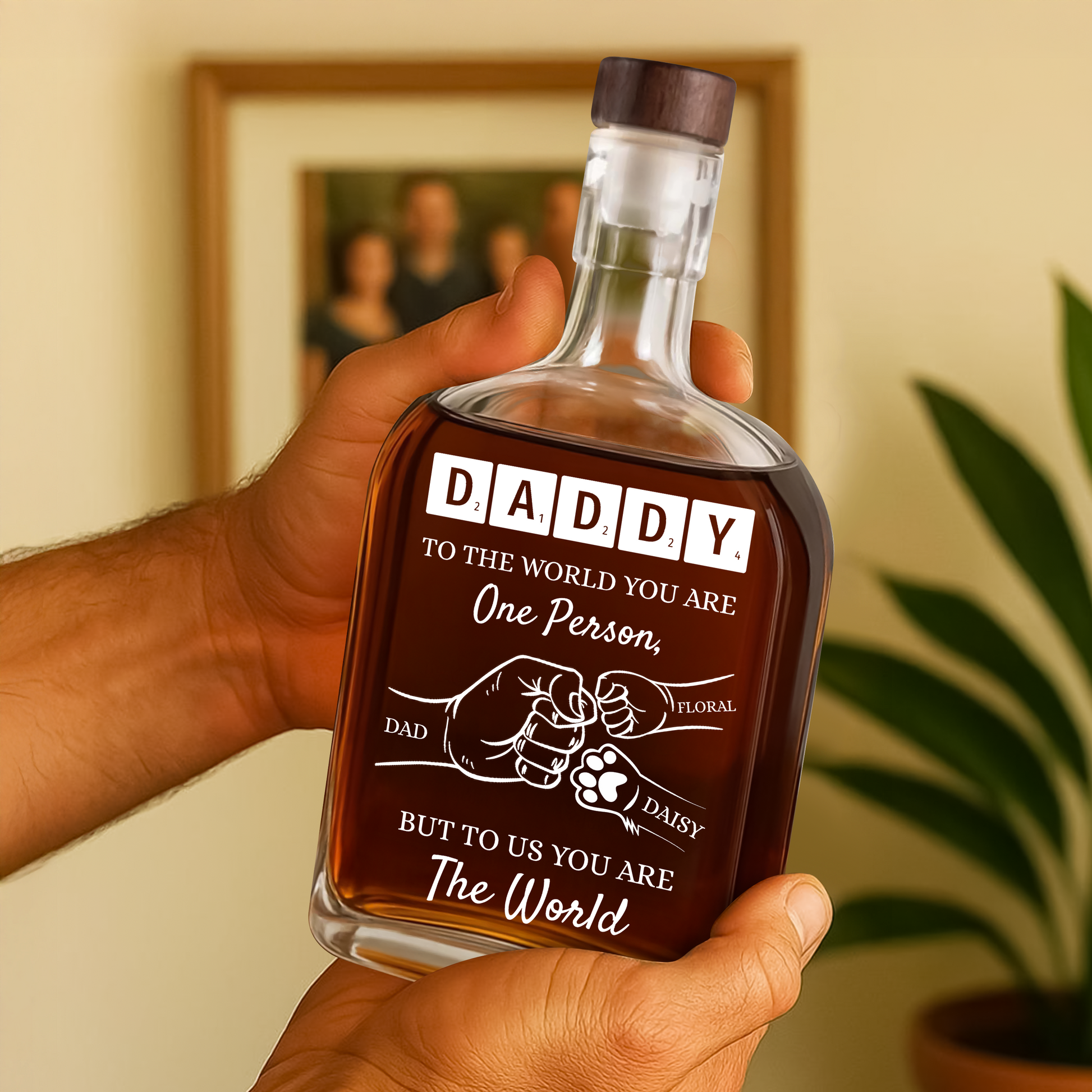 Personalized whiskey bottle with custom engraving that reads "To Your Family You Are The World, Our Family."